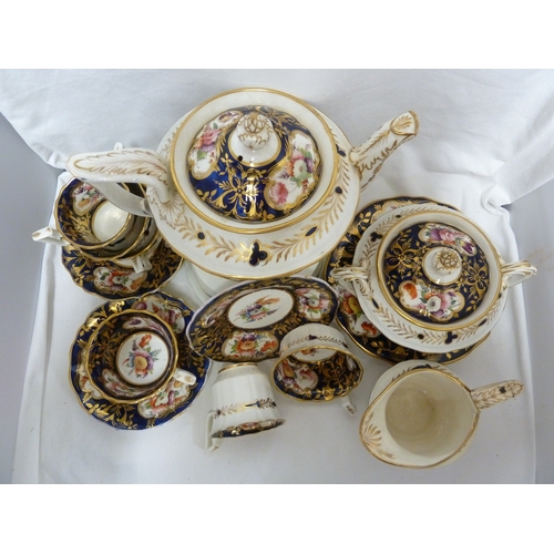 74 - An English porcelain tea and coffee service, in Coalport style, painted with mirror form cartouches ... 