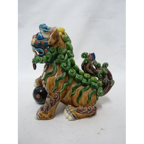 84 - A Chinese pottery Dog of Fo figure, intricately modelled with scrolled fur, bright polychrome decora... 