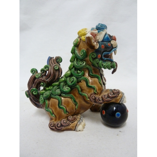 84 - A Chinese pottery Dog of Fo figure, intricately modelled with scrolled fur, bright polychrome decora... 