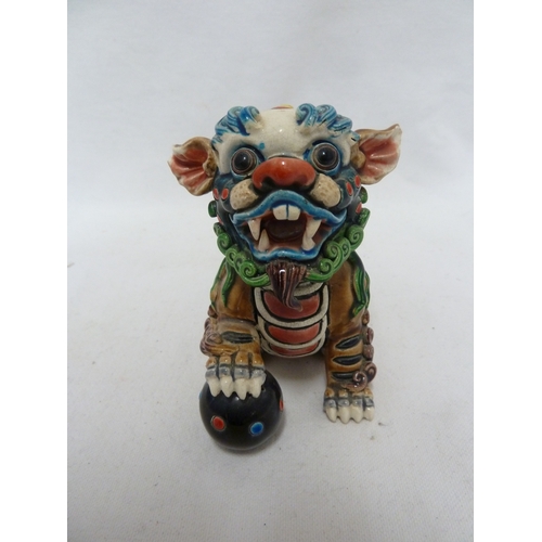 84 - A Chinese pottery Dog of Fo figure, intricately modelled with scrolled fur, bright polychrome decora... 