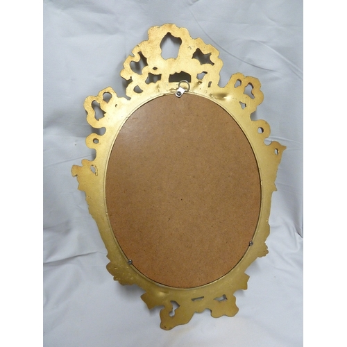 116 - A gilded metal ribbon frame looking glass, the plate oval, 44 cm max.