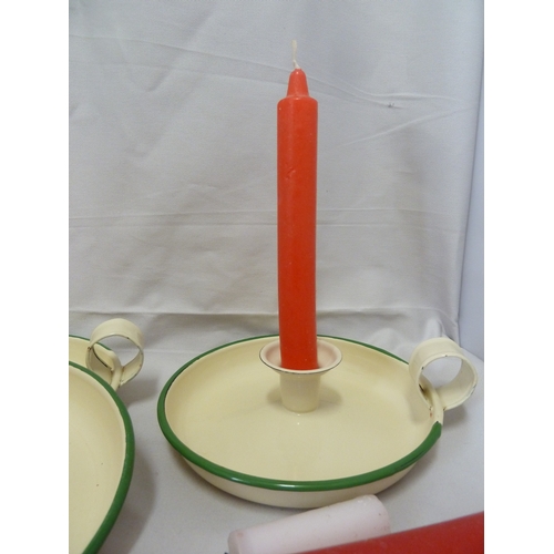 140 - Three vintage cream and green enamelled kitchenware candlesticks; and a quantity of candles (qty)