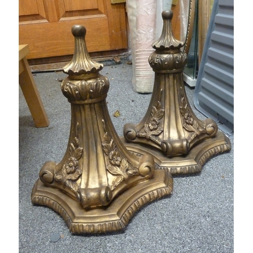 23 - Two large plaster wall sconces, gilded, the tri-form plinth tops over fluted brackets and with flore... 