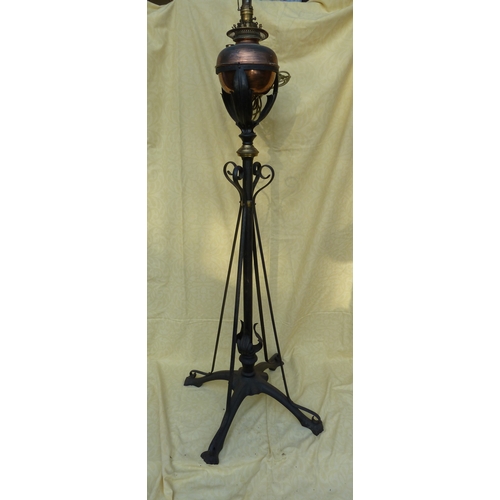 126 - An Arts and Crafts wrought iron and copper telescopic standard oil lamp, in the style of W A S Benso... 