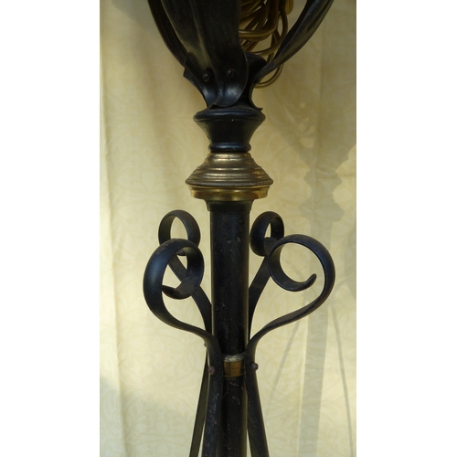 126 - An Arts and Crafts wrought iron and copper telescopic standard oil lamp, in the style of W A S Benso... 