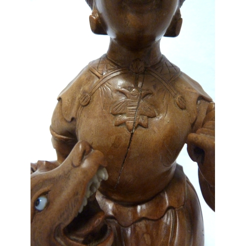 46 - A Bamboo root carving of a female figure with a dog, 22cm high approx.