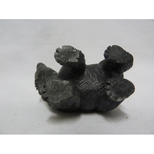 44 - A carved coal figure of a bear, with applied glass eyes, 9 cm max.