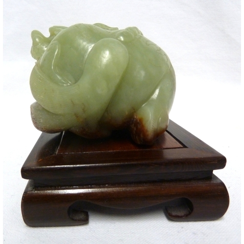 42 - A large Chinese Celedon jade figure of a Kylin, 12.5cm max; and a wooden stand (2)