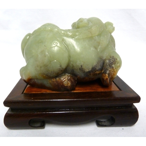 42 - A large Chinese Celedon jade figure of a Kylin, 12.5cm max; and a wooden stand (2)