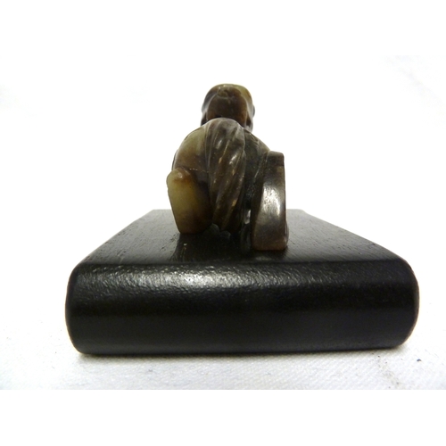 41 - A Chinese olive green jade Kylin, modelled crouching with head turned backwards, 7.5cm max; and a wo... 