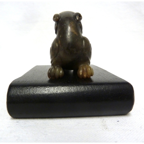 41 - A Chinese olive green jade Kylin, modelled crouching with head turned backwards, 7.5cm max; and a wo... 