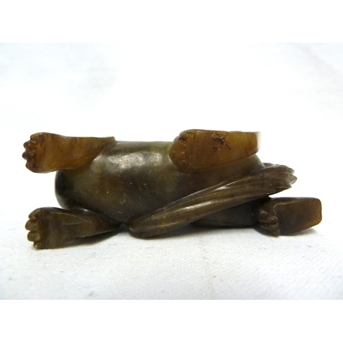 41 - A Chinese olive green jade Kylin, modelled crouching with head turned backwards, 7.5cm max; and a wo... 