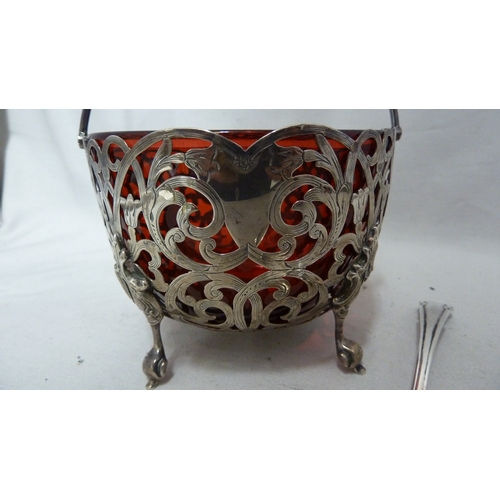 1 - A Victorian silver sugar basket, circular, the whole pierced with foliate scrolls with vacant shield... 