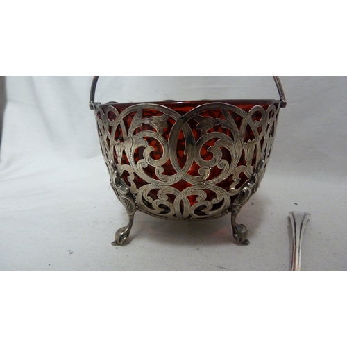 1 - A Victorian silver sugar basket, circular, the whole pierced with foliate scrolls with vacant shield... 