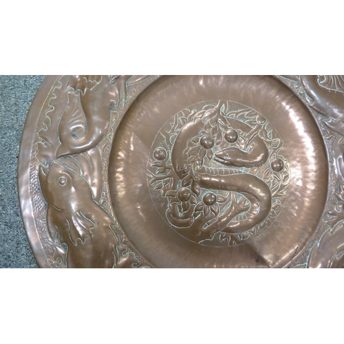 180 - An Arts and Crafts beaten copper Charger, probably Newton School Cambridgeshire, decorated with a ce... 