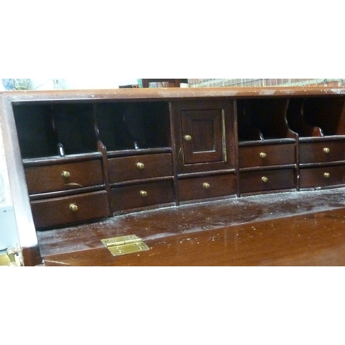 69 - A miniature fall front bureau, of two short drawers over three long, brass fittings and carry handle... 