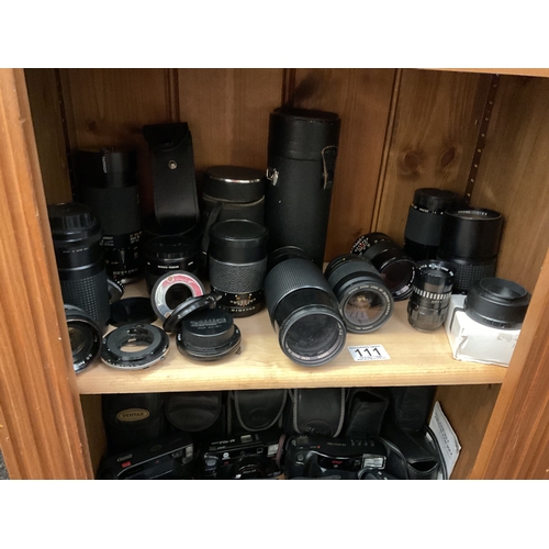 111 - Shelf of camera lenses