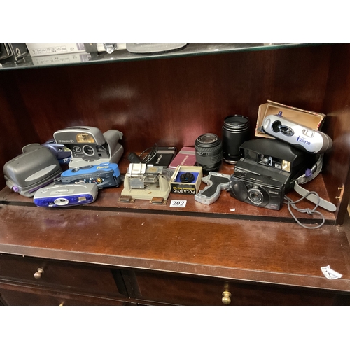 202 - Shelf of assorted cameras