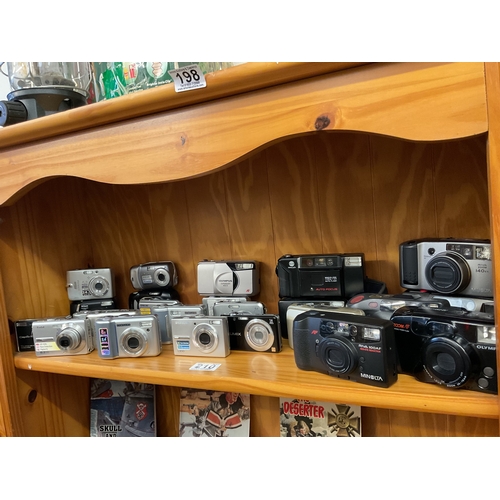 210 - Shelf assorted digital cameras, point and shoot cameras, etc.