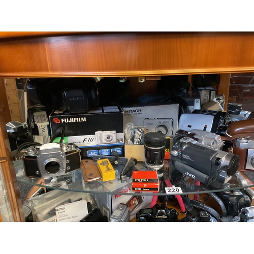 220 - Shelf of assorted cameras