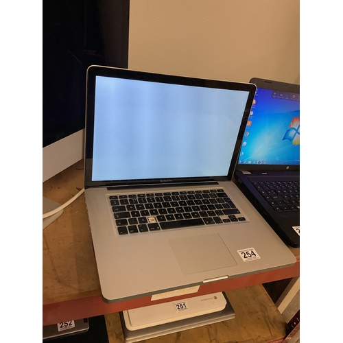 254 - MacBook Pro and charger - lights up but doesn't load