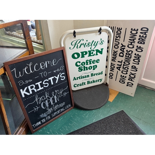 Cafe signage set — framed chalkboard, A‑frame sidewalk sign with hanging panel and weighted base, large printed parking panel.

Used with scuffs, marks and minor chip to A‑frame; Shipping Available.

Keywords: cafe sign, chalkboard, sandwich board, A‑frame, pavement sign, sidewalk sign, bakery sign, retail signage, parking sign, promotional display, shop signage