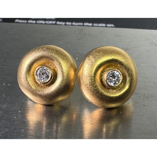 50 - 18ct (750) hallmarked gold stud earrings with central brilliant-cut diamonds — 5.65g total.

Hallmar... 