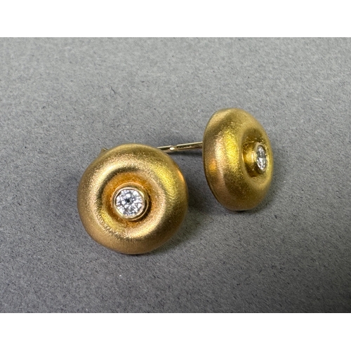 50 - 18ct (750) hallmarked gold stud earrings with central brilliant-cut diamonds — 5.65g total.

Hallmar... 