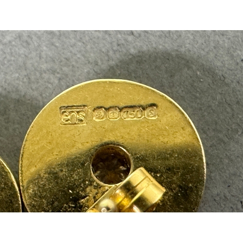 50 - 18ct (750) hallmarked gold stud earrings with central brilliant-cut diamonds — 5.65g total.

Hallmar... 