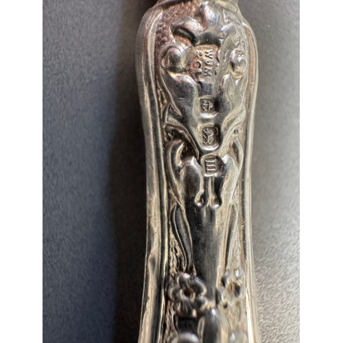 35 - Cased set of six ornate silver‑handled table knives, fitted case — 149g.

Heavily embossed silver ha... 
