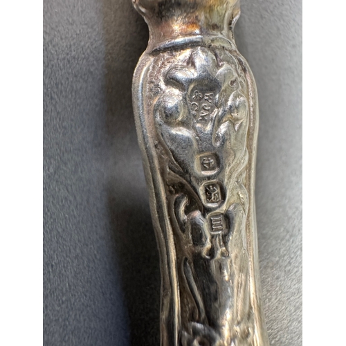 35 - Cased set of six ornate silver‑handled table knives, fitted case — 149g.

Heavily embossed silver ha... 