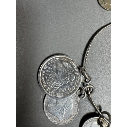 34 - Mixed silver lot — three coin‑charm bangles, cut 1939 farthing pendant on chain and assorted silver ... 