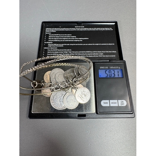 34 - Mixed silver lot — three coin‑charm bangles, cut 1939 farthing pendant on chain and assorted silver ... 