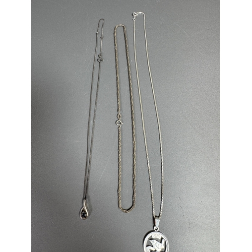34 - Mixed silver lot — three coin‑charm bangles, cut 1939 farthing pendant on chain and assorted silver ... 