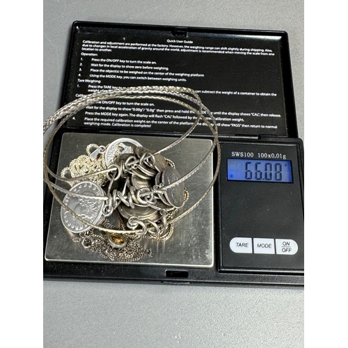 34 - Mixed silver lot — three coin‑charm bangles, cut 1939 farthing pendant on chain and assorted silver ... 