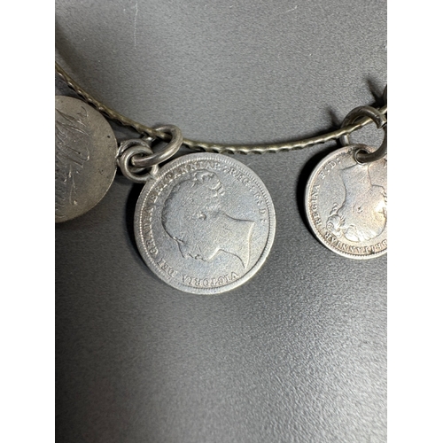 34 - Mixed silver lot — three coin‑charm bangles, cut 1939 farthing pendant on chain and assorted silver ... 
