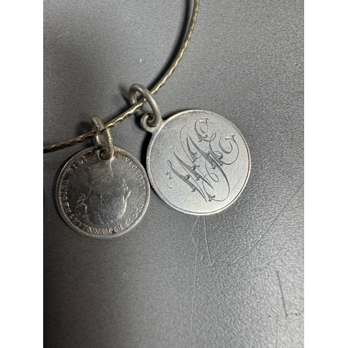 34 - Mixed silver lot — three coin‑charm bangles, cut 1939 farthing pendant on chain and assorted silver ... 