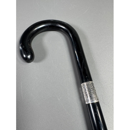 28 - Ebonised walking cane with engraved silver collar & cap, brass ferrule — approx. 95cm.

Ebonised can... 