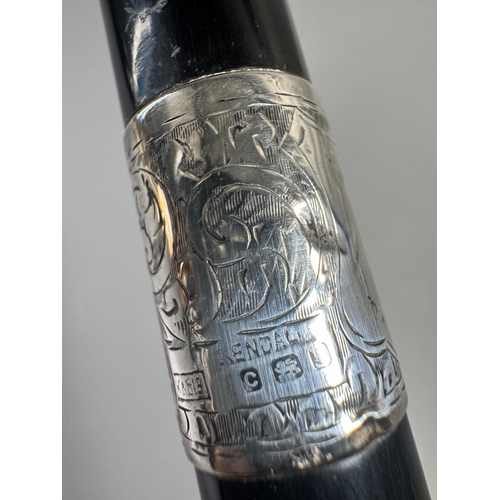 28 - Ebonised walking cane with engraved silver collar & cap, brass ferrule — approx. 95cm.

Ebonised can... 