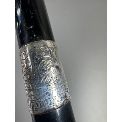 28 - Ebonised walking cane with engraved silver collar & cap, brass ferrule — approx. 95cm.

Ebonised can... 