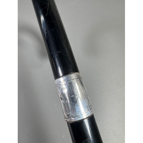 28 - Ebonised walking cane with engraved silver collar & cap, brass ferrule — approx. 95cm.

Ebonised can... 