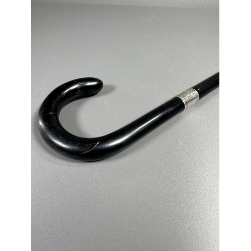 28 - Ebonised walking cane with engraved silver collar & cap, brass ferrule — approx. 95cm.

Ebonised can... 