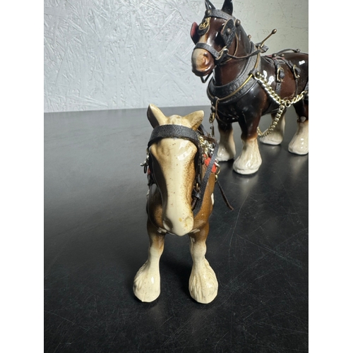 595 - Pair of Beswick-Style Shire Horses with Full Harness (Shipping Available).

A charming pair of ceram... 