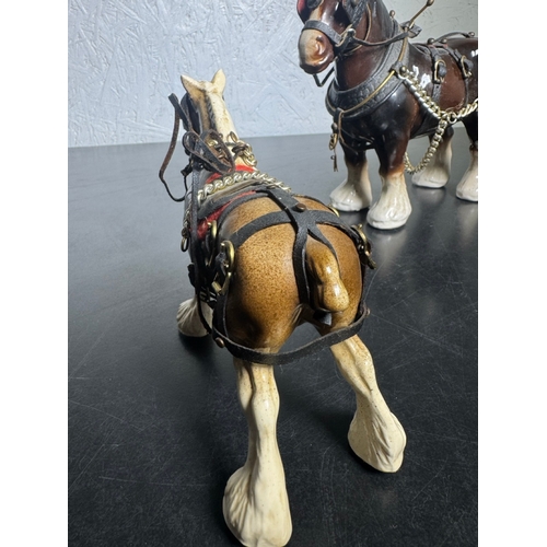 595 - Pair of Beswick-Style Shire Horses with Full Harness (Shipping Available).

A charming pair of ceram... 