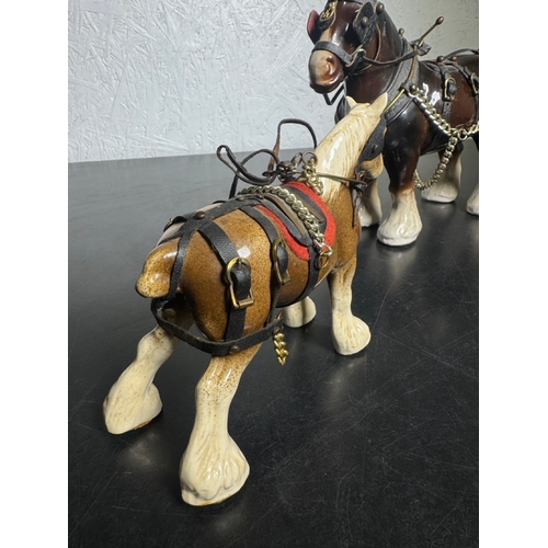 595 - Pair of Beswick-Style Shire Horses with Full Harness (Shipping Available).

A charming pair of ceram... 