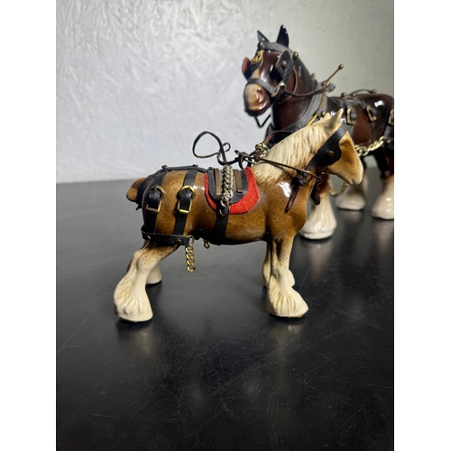 595 - Pair of Beswick-Style Shire Horses with Full Harness (Shipping Available).

A charming pair of ceram... 