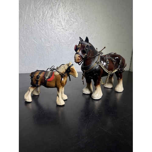 595 - Pair of Beswick-Style Shire Horses with Full Harness (Shipping Available).

A charming pair of ceram... 