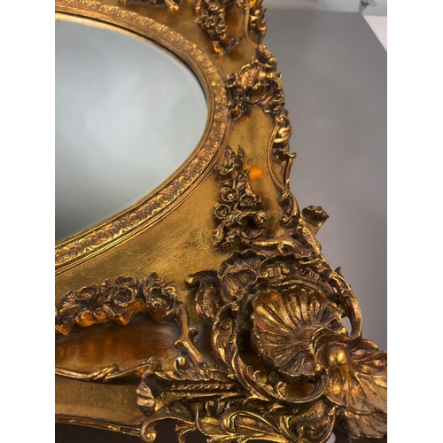 A Large 20th Century Rococo Revival Gilt Framed Wall Mirror A large ...