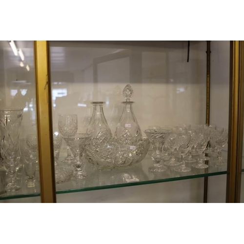 92 - A selection of cut glass, drinking glasses, decanters etc