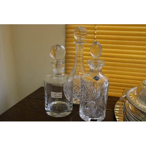 235 - Three glass decanters